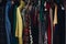 Rack of different clothing in wardrobe in fashionable store.