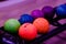 Rack filled with a colorful assortment of rainbow-hued bowling balls