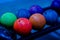 Rack filled with a colorful assortment of rainbow-hued bowling balls