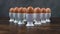 Rack focus shot of a group of boiled eggs in white egg cups on a wooden kitchen table