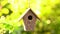 Rack focus video clip of a bird house hanging in a tree in a garden during summer