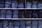 Rack with folded jeans, a lot of jeans, lying on a shelf in the store, textural background