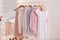 Rack with stylish women`s clothes and mirror. Interior design