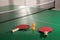 Rackets and balls on ping pong table indoors