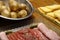 Raclette cheese with meats (ham, sausage) and potatoes