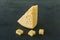 Radamer cheese on a plate served with honey. triangular piece of yellow cow`s milk swiss cheese with holes