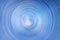 Radial spiral ripple blue background