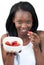 Radiant Afro-american a woman eating strawberries
