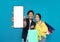 Radiant Asian couple playfully interacting with a blank smartphone screen