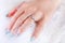 Radiant Beauty: Diamond Ring and Blue Manicure
