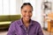 Radiant black lady student with delightful smile in purple shirt