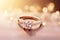 A radiant diamond engagement ring set on a rose gold band, illuminated by soft bokeh lights.