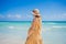 Radiant and expecting, a pregnant woman stands on a pristine snow-white tropical beach, celebrating the miracle of life