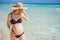 Radiant and expecting, a pregnant woman stands on a pristine snow-white tropical beach, celebrating the miracle of life