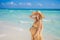 Radiant and expecting, a pregnant woman stands on a pristine snow-white tropical beach, celebrating the miracle of life