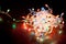 Radiant Festive Glow: Close-up of Colorful Christmas Lights on Wooden Desk