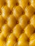 Radiant, gilded tufted cushions with a high-shine, gleaming finish, creating a visually striking and luxurious