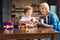 Radiant granny helping her grandson with car building