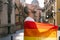 Radiant Man: Smiling under Sunset Glow, Holding LGBT Flag on Sunny City Street