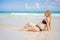 Radiant pregnant woman in a swimsuit, amid the stunning backdrop of a turquoise sea. Serene beauty of maternity by the