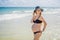 Radiant pregnant woman in a swimsuit, amid the stunning backdrop of a turquoise sea. Serene beauty of maternity by the