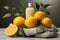 Radiant skincare exhibit, oranges and products on stone podium against white backdrop