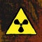 Radiation hazard sign on a grunge background. Brush, paint, ink. Vector illustration.