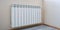 Radiator heating, white radiator in the apartment. Hand felt the coldness. Heating is turned off for non-payment.