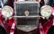 Radiatori and headlights of a classic burgundy red Packard sports car