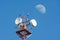 Radio antenna tower over blue sky and moon