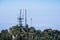 Radio antennas on the mountains of Angeles National Forest, haze covering the valley in the background; Los Angeles county,