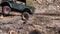 Radio control military jeep overcomes obstacles.