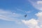 Radio controlled toy airplane against blue sky with white clouds