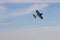 Radio controlled toy airplane against blue sky with white clouds