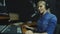 A radio DJ reads news in the broadcasting studio