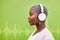 Radio headphones, profile and black woman listening on green wall background mockup space. Music, audio and African