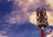 A radio mast below a cloudy summer sky