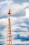 Radio mast tower with antennas for telecommunications and broadcasting and stormy cloudy sky. Vertical photo