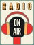 Radio station on air typographic poster with microphone and headphones. Retro vector illustration.