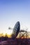 Radio telescope dish satellite equipment at sunset landscape