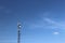 Radio tower with antennas on a blue sky background. Metal construction. Wireless tezhnologii. Transmission of a tele-radio signal.