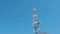 Radio, tv and mobile communication tower against of blue clear sky. Telecommunications tower with blue sky on background