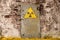 Radioactive ionizing radiation danger symbol painted on the old massive rusted iron door