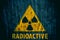 Radioactive ionizing radiation danger symbol with word radioactive below painted on a massive concrete wall
