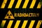 Radioactive ionizing radiation or nuclear energy danger symbol and word yellow and black stripes