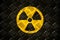 Radioactive ionizing radiation round yellow and black danger symbol painted on a massive steel checker metal diamond plate