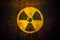 Radioactive: round yellow radioactive ionizing radiation danger symbol painted on a massive rusty metal wall.