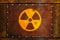 Radioactive: Round yellow radioactive ionizing radiation danger warning symbol on massive rusty metal plate fixed with screws