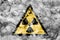 Radioactive substances or ionising radiation hazard warning smoke sign. Triangular warning hazard sign, smoke background.