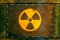 Radioactive symbol: yellow nuclear radioactive ionizing radiation danger warning symbol painted on a massive rusty metal plate